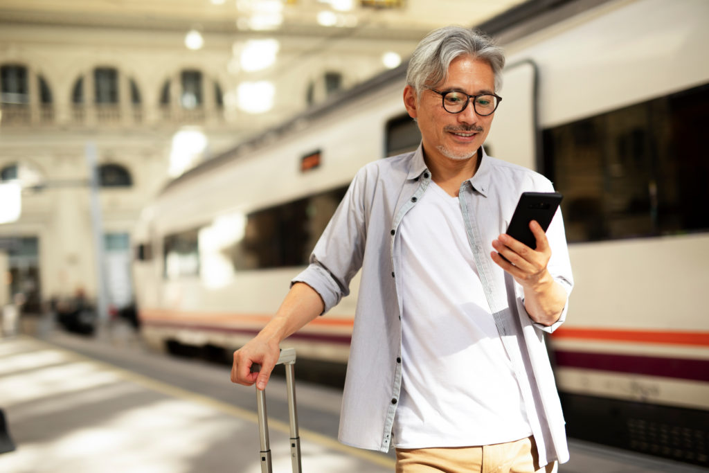 Happy solo traveler train station trip to Switzerland